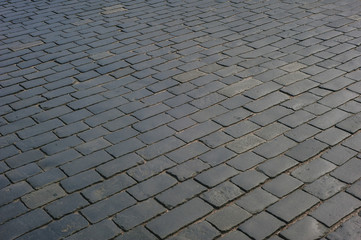 Abstract background of old cobblestone pavement close-up.