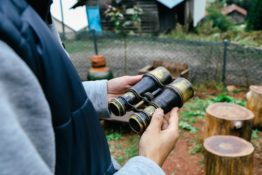 Old binoculars in hand