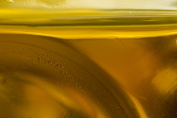 Macro photo. The bottom of the plastic bottle. The level of yellow  oil.Site about the kitchen, photography, art, abstraction, food industry.
