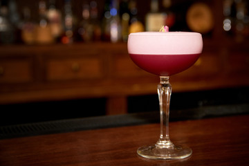 Red cocktail at bar