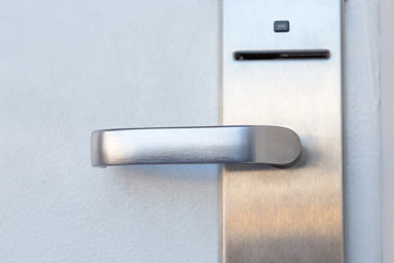 Modern metal door handle with security system lock