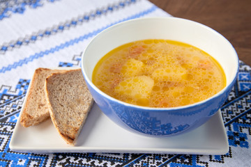 Potato soup in bowl with bread