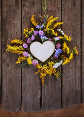 wooden heart,summer flowers over old table  / toned/birthday, love,mothers day,thanksgiving,herbal medicine  background