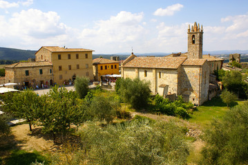 Fototapeta na wymiar Church of Santa Maria Assunta and overview of Monteriggioni, Chianti Region, Province of Siena, Tuscany, Italy