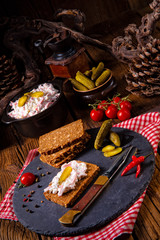Fototapeta na wymiar delicious spicy meat salad with cucumber on the black bread