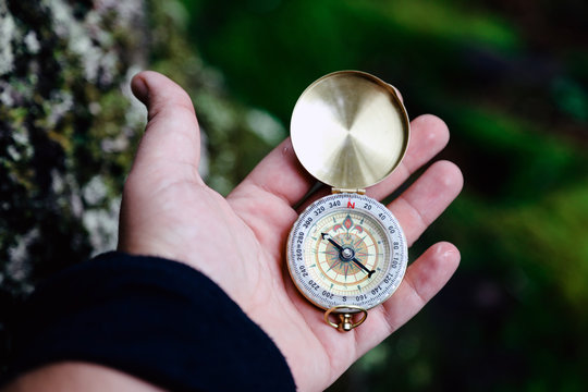 Compass in Hand Natural background .Vintage Tone.