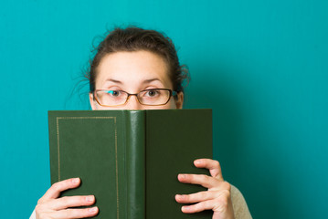 beautiful brunette girl in glasses with book