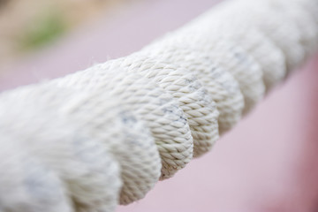 White sea rope close-up on a wharf in the summer