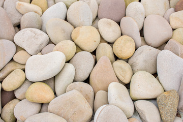 Several round beautiful smooth stones on the seashore