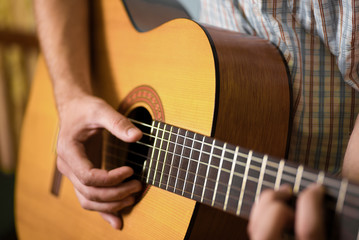 Fototapeta premium man playing classical acoustic guitar