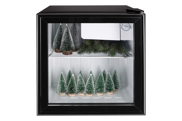 abstract christmas idea, refrigerator with a transparent door, inside a lot of Christmas trees, concept of holiday shopping, and lending, on white background, isolate