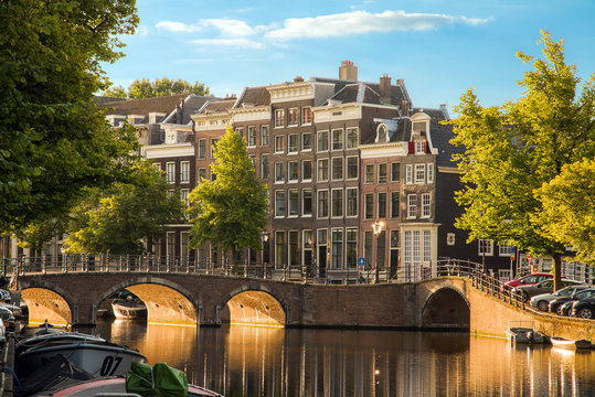 Beautiful view of the iconic UNESCO world heritage Keizersgracht canal  in Amsterdam, the Netherlands, on a sunny summer morning with sunshine, a blue sky and reflection