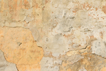 texture of old peeling yellow plaster