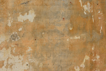 texture of old peeling yellow plaster