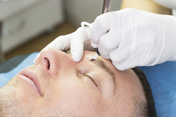 Obraz na płótnie Canvas Microblading eyebrows workflow in a beauty salon