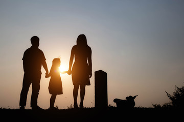 Silhouette of a family enjoying a beautiful sunset