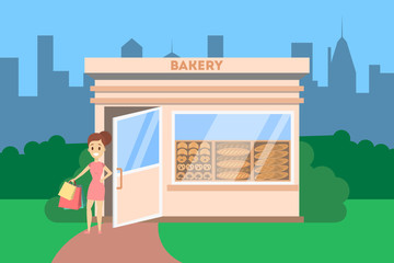 Fototapeta premium Woman going out of the bakery shop with bread