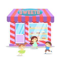 Children running in front of candy shop.