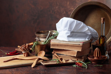 White chef's hat and old cookbooks.