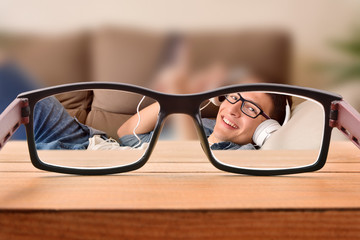 Vision concept with teenager with glasses entertaining lying