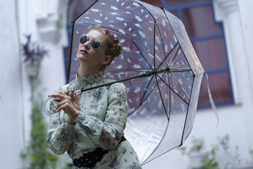 Fashion woman with sunglasses and an umbrella