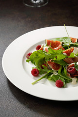 Fresh salad with prosciutto and figs