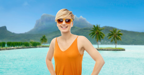 travel, tourism and summer holidays concept - happy smiling teenage girl in sunglasses at touristic...
