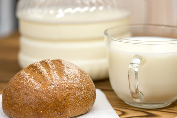 a glass of milk and bread with a bottle of milk