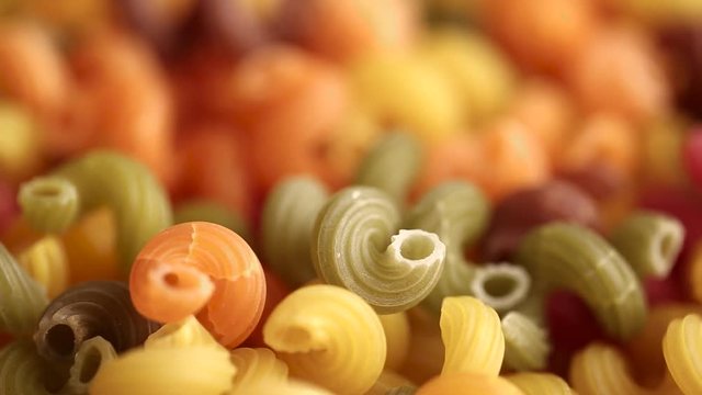 multicolored swirling pasta noodles. the image is blurred, then sharpened