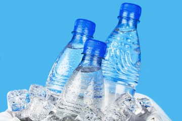 Three Bottles of Water in Ice Bucket on the Blue Background © BillionPhotos.com