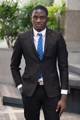 serious and confident african or black businessman; portrait of confident, successful african or black business man, manager, business executive CEO; young adult african man model