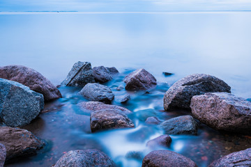The water flow or stream running to the gulf of the sea among the rocks and stones 