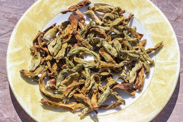 Close-up view of string beans dried under the sunlight on the plate