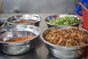 A market stall full of ingredients for Chinese traditional noodles. Jalan Petaling, Kuala Lumpur, Malaysia