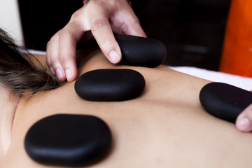 Massage with stones. Stones on the back close up