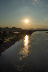 Fototapeta premium Early morning sunrise sun reflection on a river in Chattanooga, Tennessee
