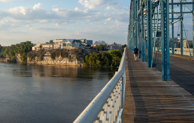 Fototapeta premium Man walking on bridge toward landmark in Chattanooga, Tennessee,