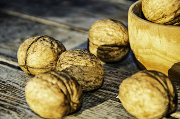 Harvest of a walnut in a garden on a wooden background.