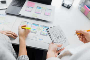 app design, technology and business concept - web designers working on user interface project and...