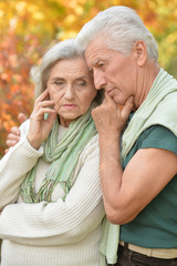 Portrait of Sad senior couple in park