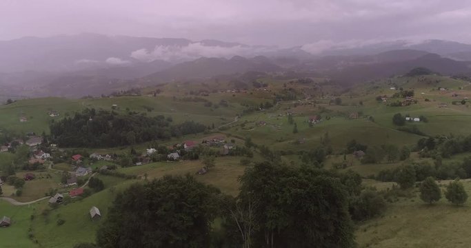 Aerial view of rural landscape on a rainy day with overcast sky.
