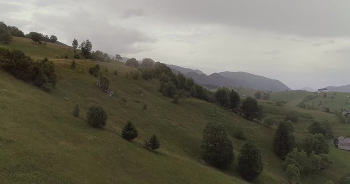 Aerial view of rural landscape on a rainy day with overcast sky.