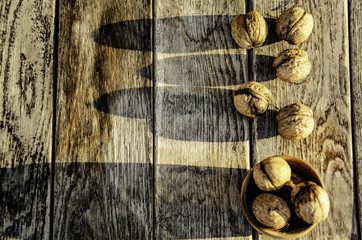 Harvest of a walnut in a garden on a wooden background.