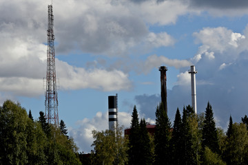 Antenna and tree pipes against the blue sky