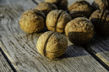 Harvest of a walnut in a garden on a wooden background.