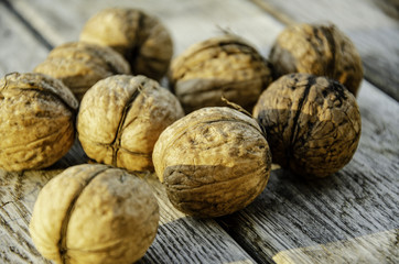 Harvest of a walnut in a garden on a wooden background.