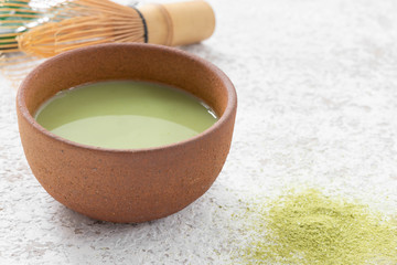 green tea latte in Japan cup with tea whisk for matcha

