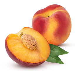 Ripe peach fruit one cut in half with bone and leaf
