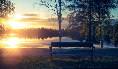 enjoying the sunset on a bench at lake päijänne