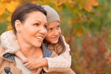 Portrait of mother and daughter hugging in park